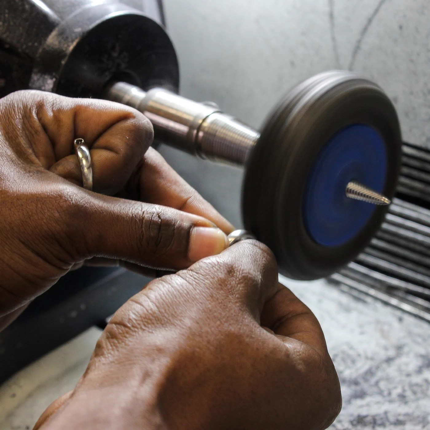 A ring being polished on the wheel by hand at the Prins and Prins workshop
